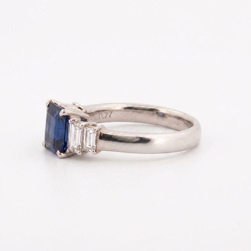 Emerald Step-Cut, AAA Natural Blue Sapphire (1.15CT, 7x5mm), Mounted on Platinum 900 Ring with Natural Diamonds (0.77 CTW, E/F VS1/VS2). Size 7.25