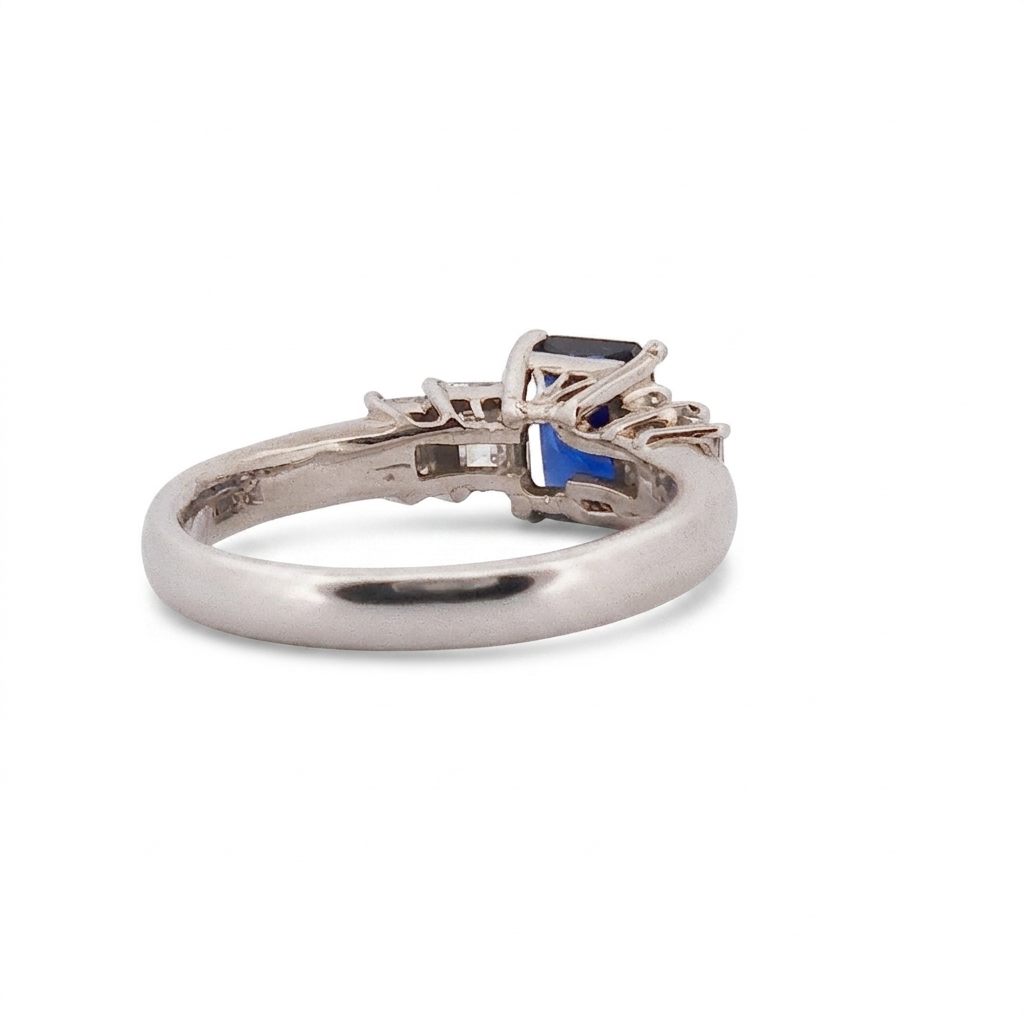 Emerald Step-Cut, AAA Natural Blue Sapphire (1.15CT, 7x5mm), Mounted on Platinum 900 Ring with Natural Diamonds (0.77 CTW, E/F VS1/VS2). Size 7.25