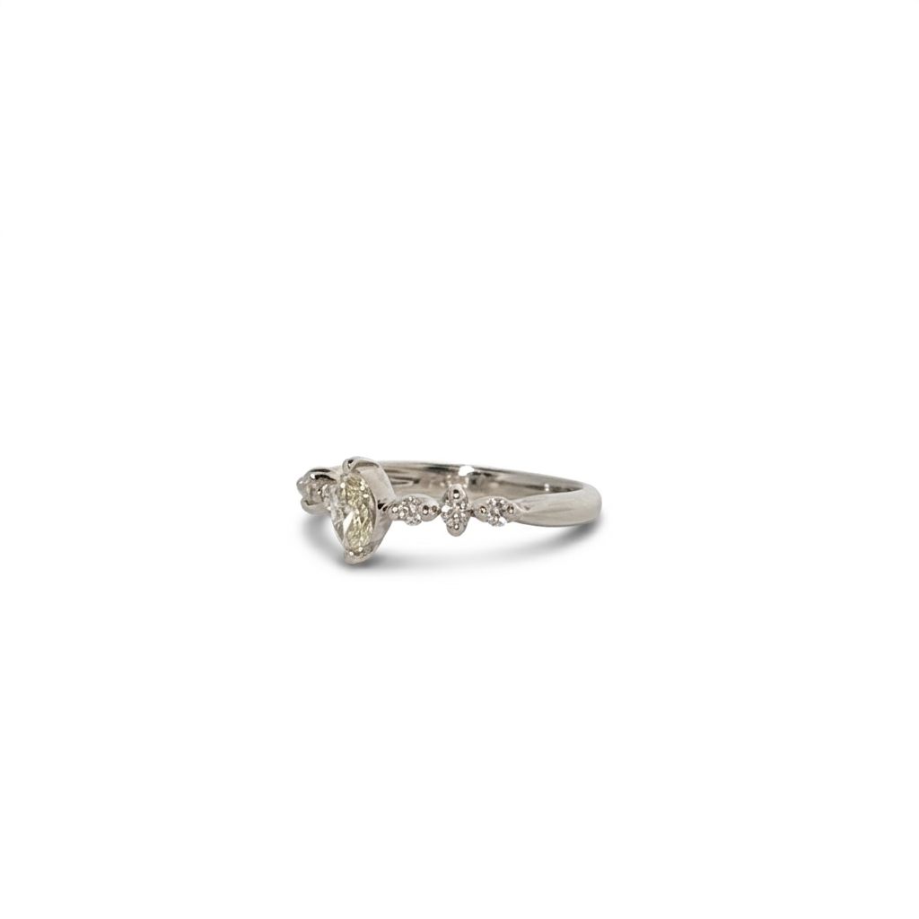 Platinum 900 Engagement Ring, size 6, set with 1 Marquise Diamond (0.28ct, I, SI2) and 6 Round Diamonds (0.15ct total, G, SI1).