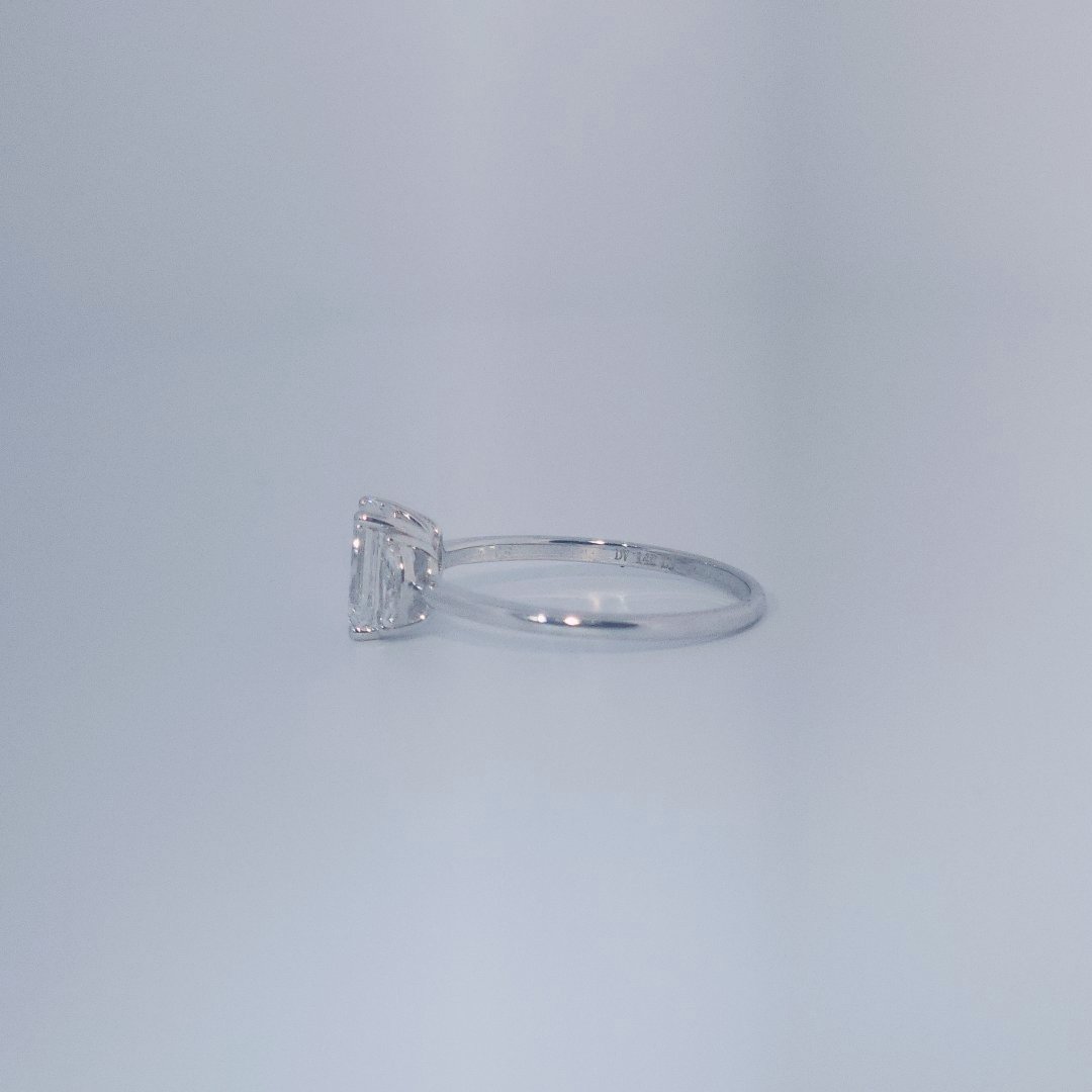 Female Wedding Ring, 14K White Gold, emerald-cut central Diamond (E/VS1, 1.02ct) flanked by 2 round Diamonds (0.25ct total).