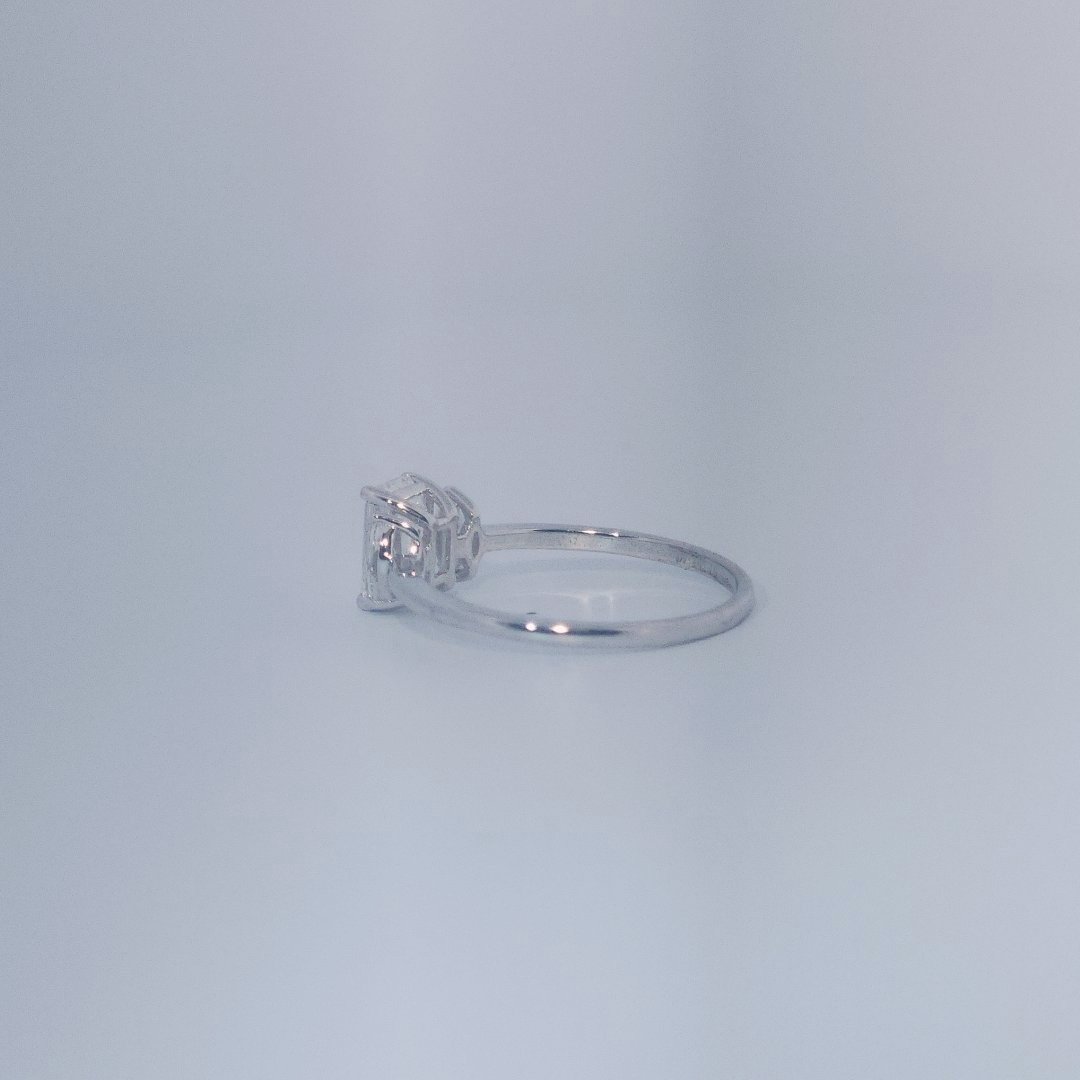 Female Wedding Ring, 14K White Gold, emerald-cut central Diamond (E/VS1, 1.02ct) flanked by 2 round Diamonds (0.25ct total).