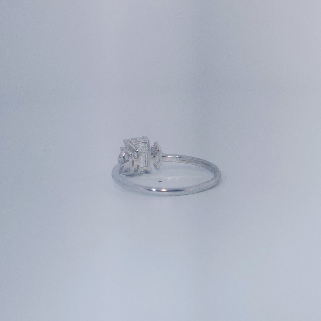 Female Wedding Ring, 14K White Gold, emerald-cut central Diamond (E/VS1, 1.02ct) flanked by 2 round Diamonds (0.25ct total).