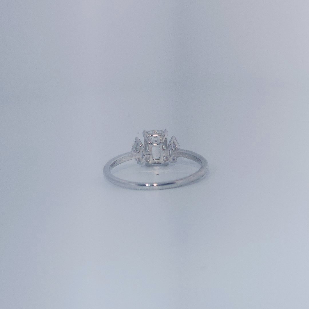 Female Wedding Ring, 14K White Gold, emerald-cut central Diamond (E/VS1, 1.02ct) flanked by 2 round Diamonds (0.25ct total).