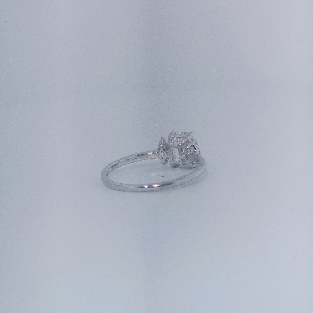Female Wedding Ring, 14K White Gold, emerald-cut central Diamond (E/VS1, 1.02ct) flanked by 2 round Diamonds (0.25ct total).