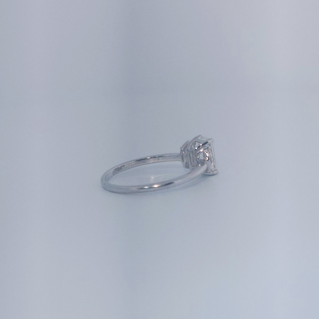 Female Wedding Ring, 14K White Gold, emerald-cut central Diamond (E/VS1, 1.02ct) flanked by 2 round Diamonds (0.25ct total).
