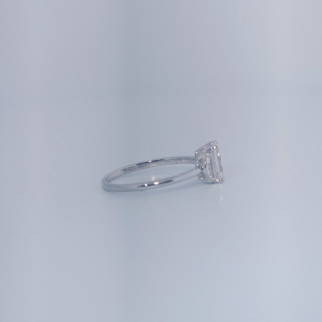 Female Wedding Ring, 14K White Gold, emerald-cut central Diamond (E/VS1, 1.02ct) flanked by 2 round Diamonds (0.25ct total).