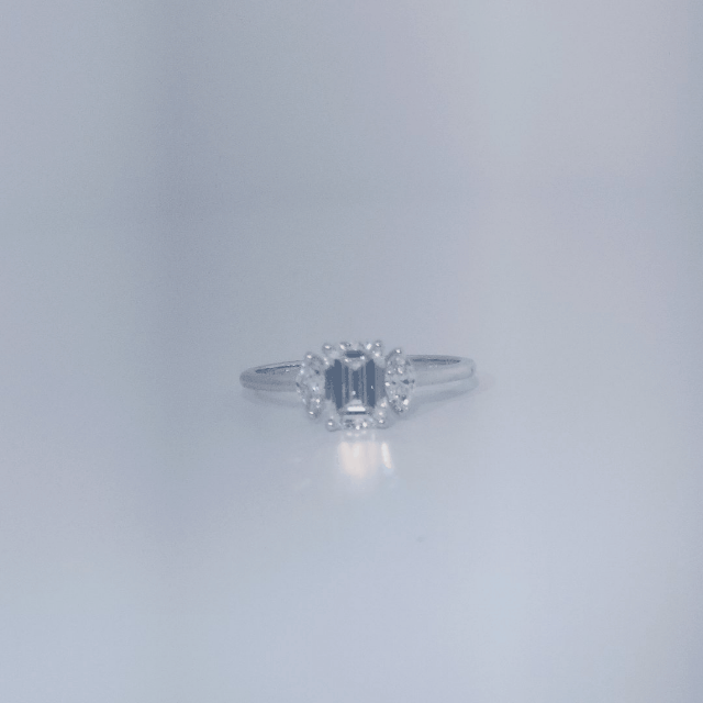 Female Wedding Ring, 14K White Gold, emerald-cut central Diamond (E/VS1, 1.02ct) flanked by 2 round Diamonds (0.25ct total).
