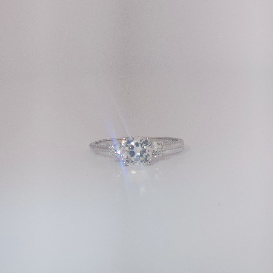 Women's Three-Stone Ring in 14K White Gold featuring a 1.03ct E/VS2 center Diamond flanked by two 0.29ct Diamonds.