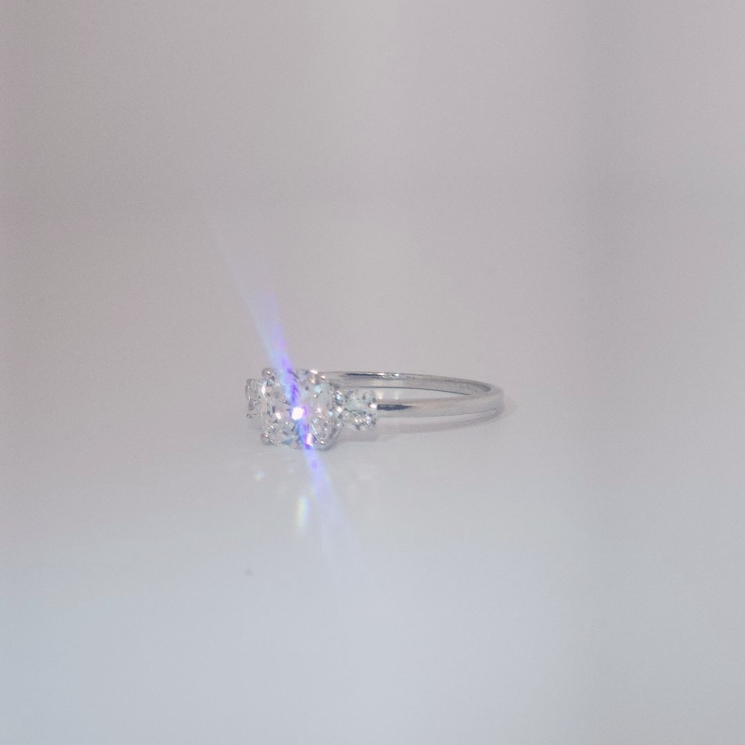 Women's Three-Stone Ring in 14K White Gold featuring a 1.03ct E/VS2 center Diamond flanked by two 0.29ct Diamonds.