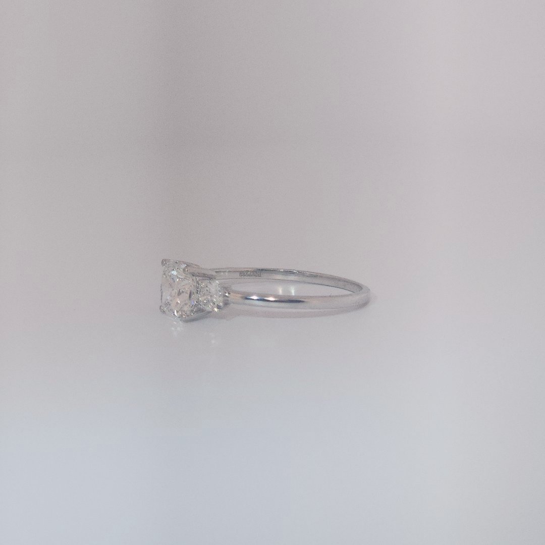 Women's Three-Stone Ring in 14K White Gold featuring a 1.03ct E/VS2 center Diamond flanked by two 0.29ct Diamonds.