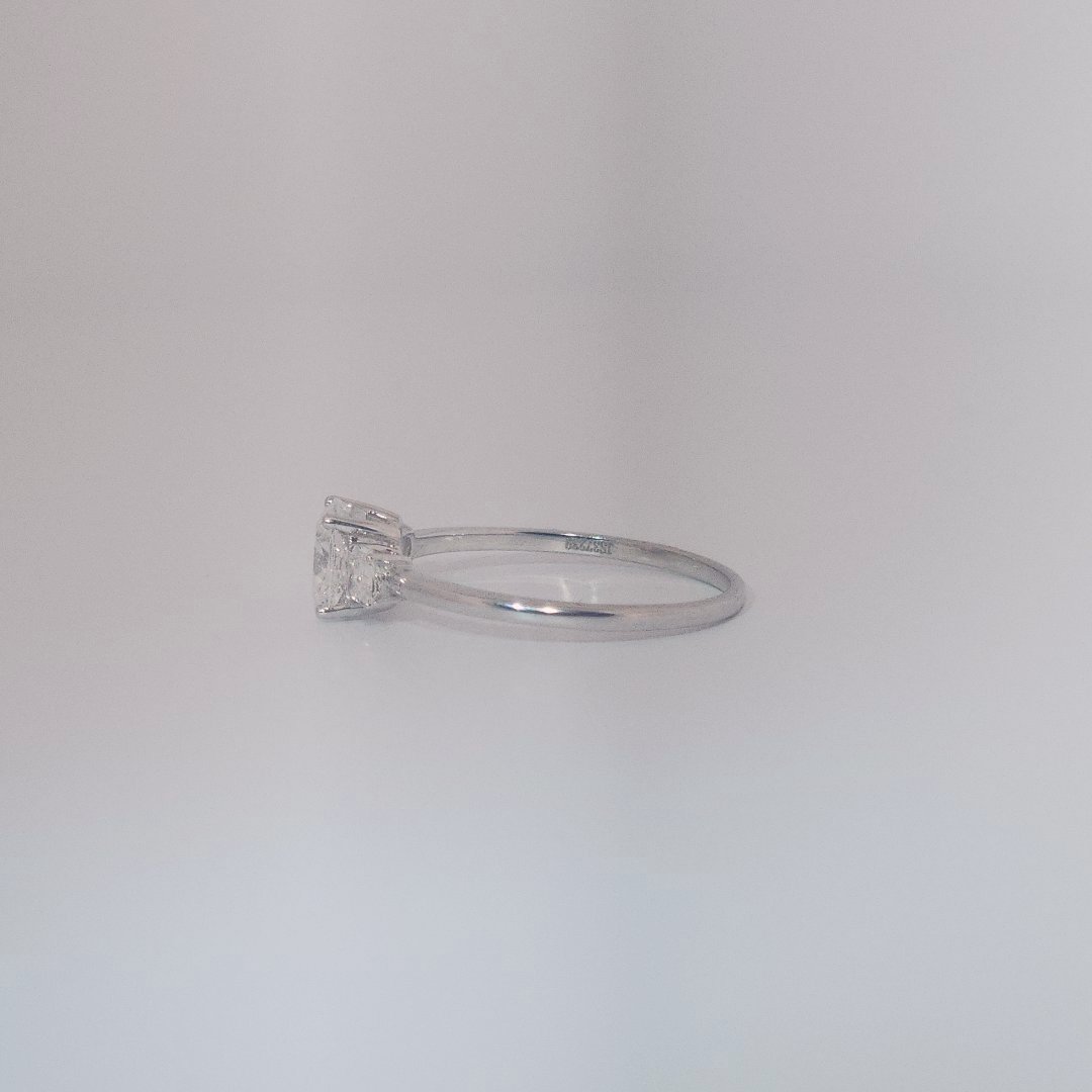 Women's Three-Stone Ring in 14K White Gold featuring a 1.03ct E/VS2 center Diamond flanked by two 0.29ct Diamonds.