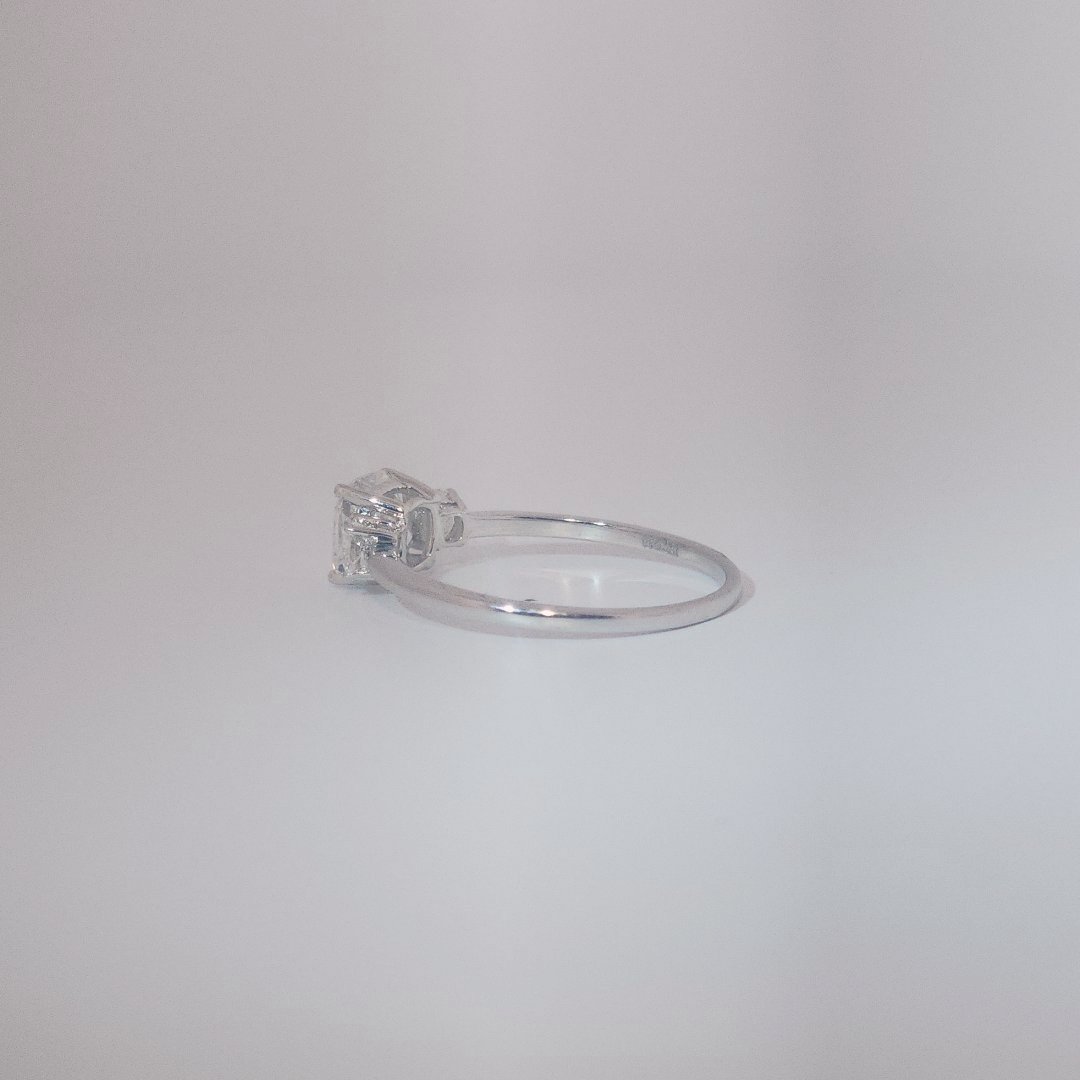 Women's Three-Stone Ring in 14K White Gold featuring a 1.03ct E/VS2 center Diamond flanked by two 0.29ct Diamonds.