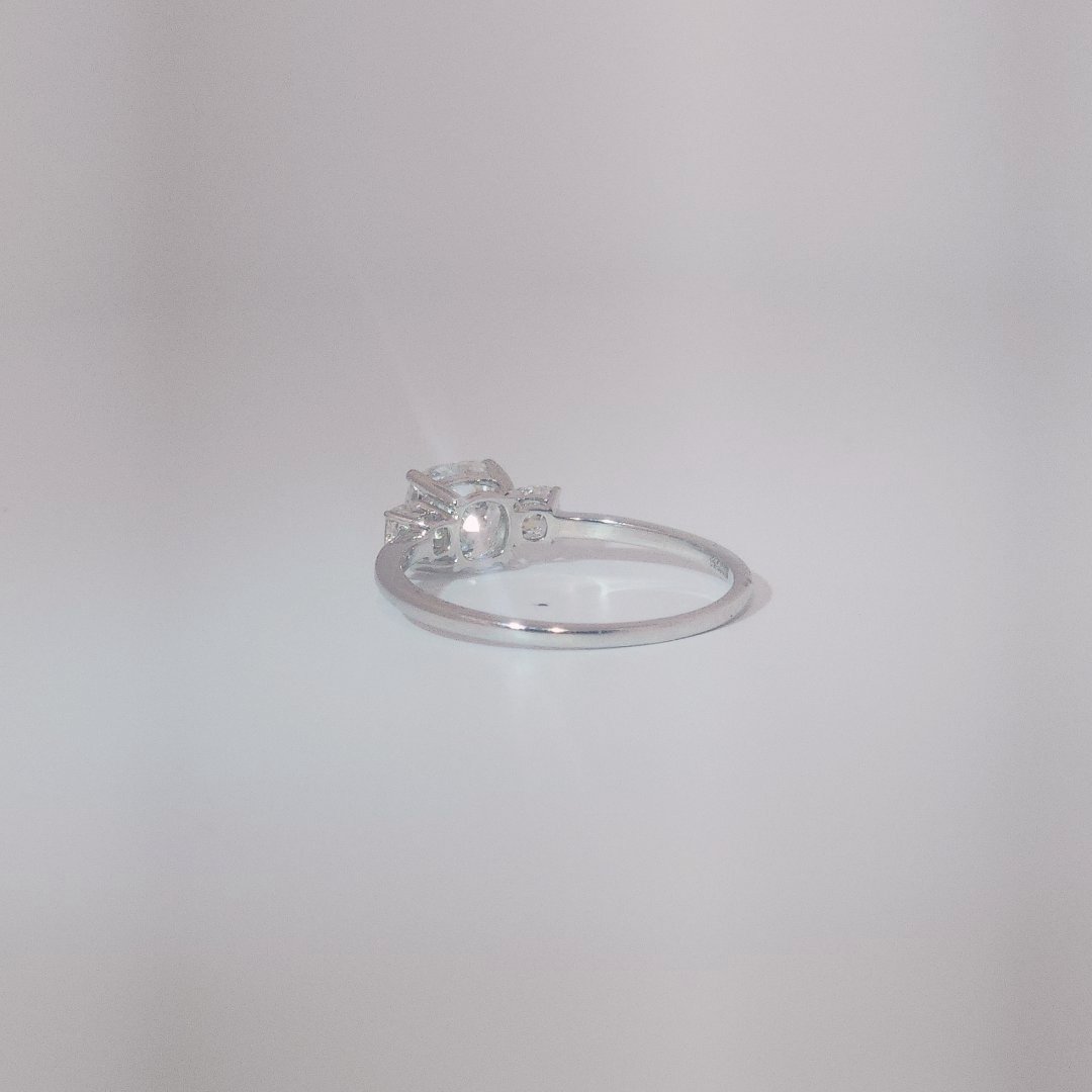 Women's Three-Stone Ring in 14K White Gold featuring a 1.03ct E/VS2 center Diamond flanked by two 0.29ct Diamonds.