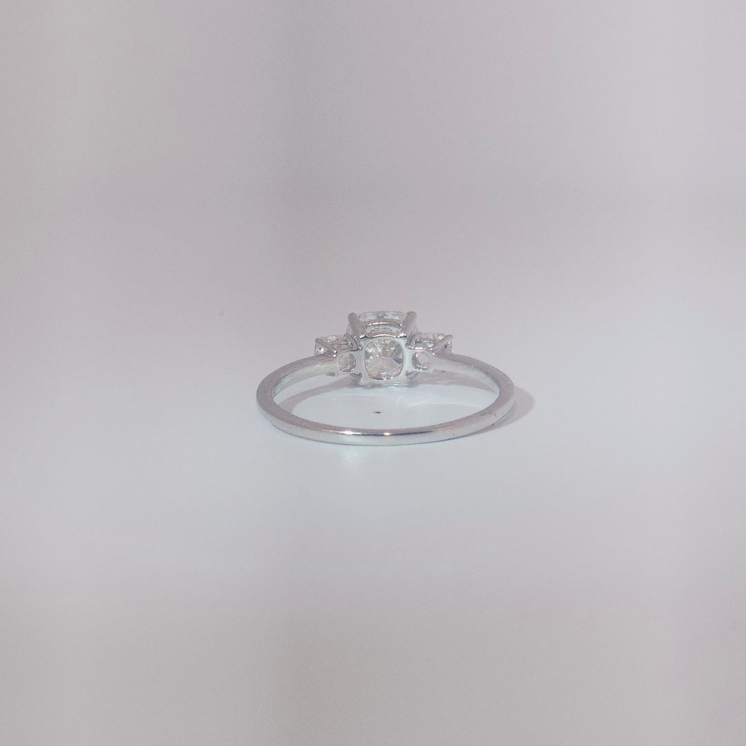 Women's Three-Stone Ring in 14K White Gold featuring a 1.03ct E/VS2 center Diamond flanked by two 0.29ct Diamonds.