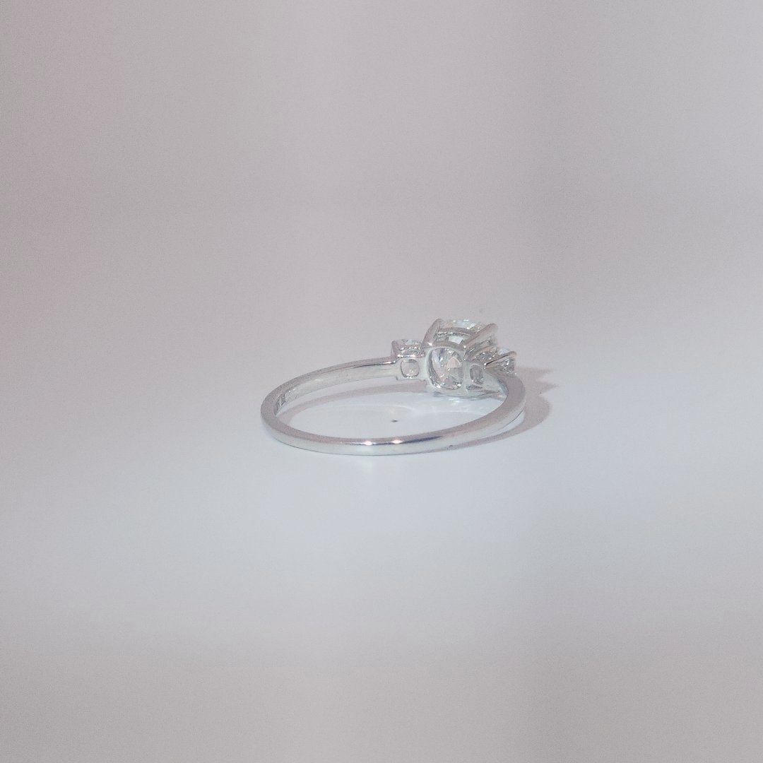 Women's Three-Stone Ring in 14K White Gold featuring a 1.03ct E/VS2 center Diamond flanked by two 0.29ct Diamonds.