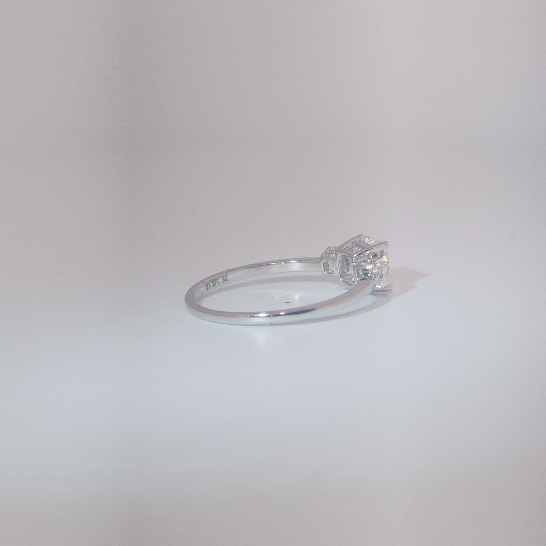 Women's Three-Stone Ring in 14K White Gold featuring a 1.03ct E/VS2 center Diamond flanked by two 0.29ct Diamonds.