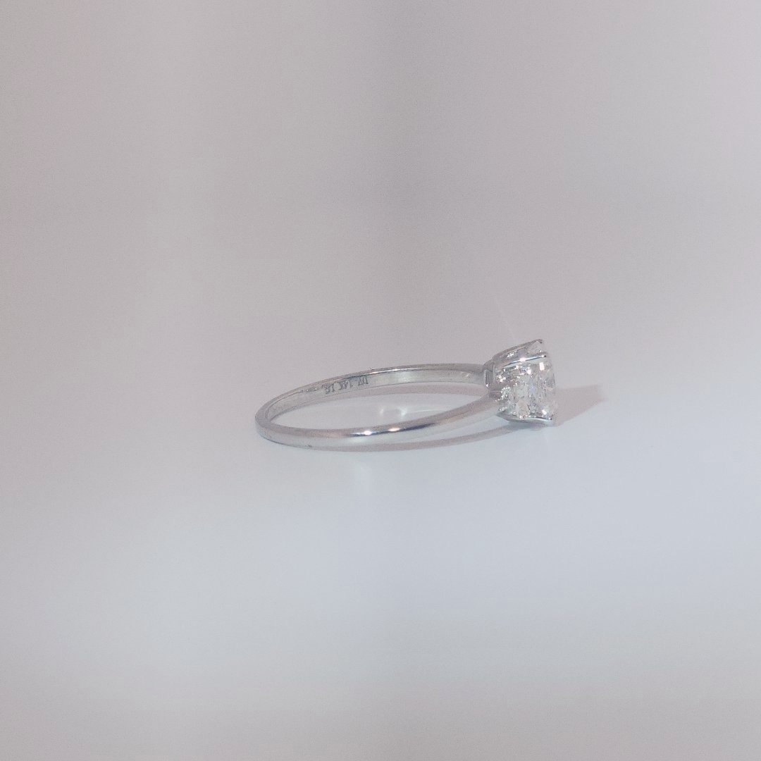 Women's Three-Stone Ring in 14K White Gold featuring a 1.03ct E/VS2 center Diamond flanked by two 0.29ct Diamonds.