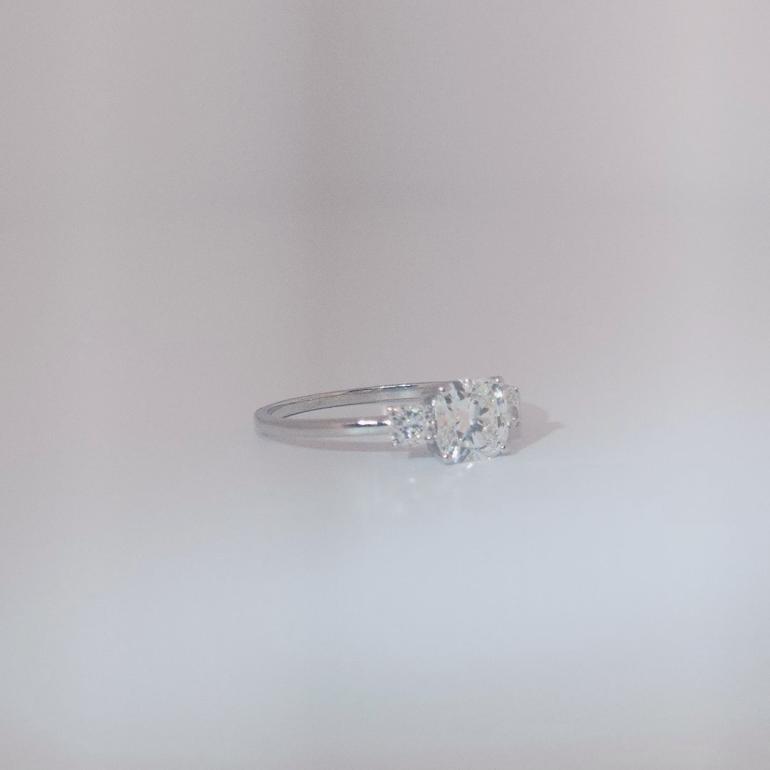 Women's Three-Stone Ring in 14K White Gold featuring a 1.03ct E/VS2 center Diamond flanked by two 0.29ct Diamonds.