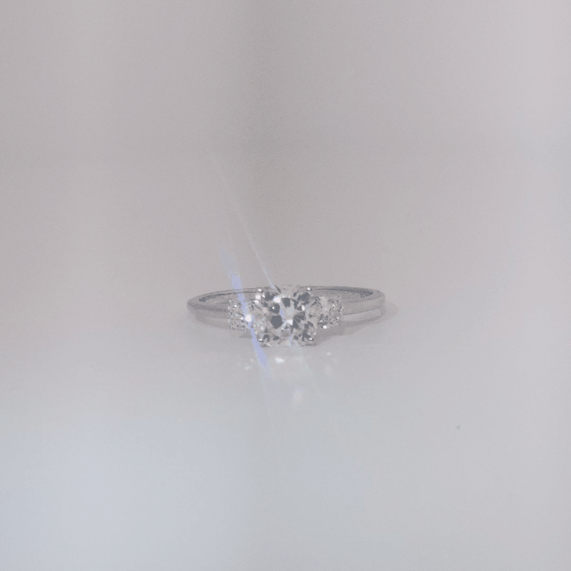 Women's Three-Stone Ring in 14K White Gold featuring a 1.03ct E/VS2 center Diamond flanked by two 0.29ct Diamonds.