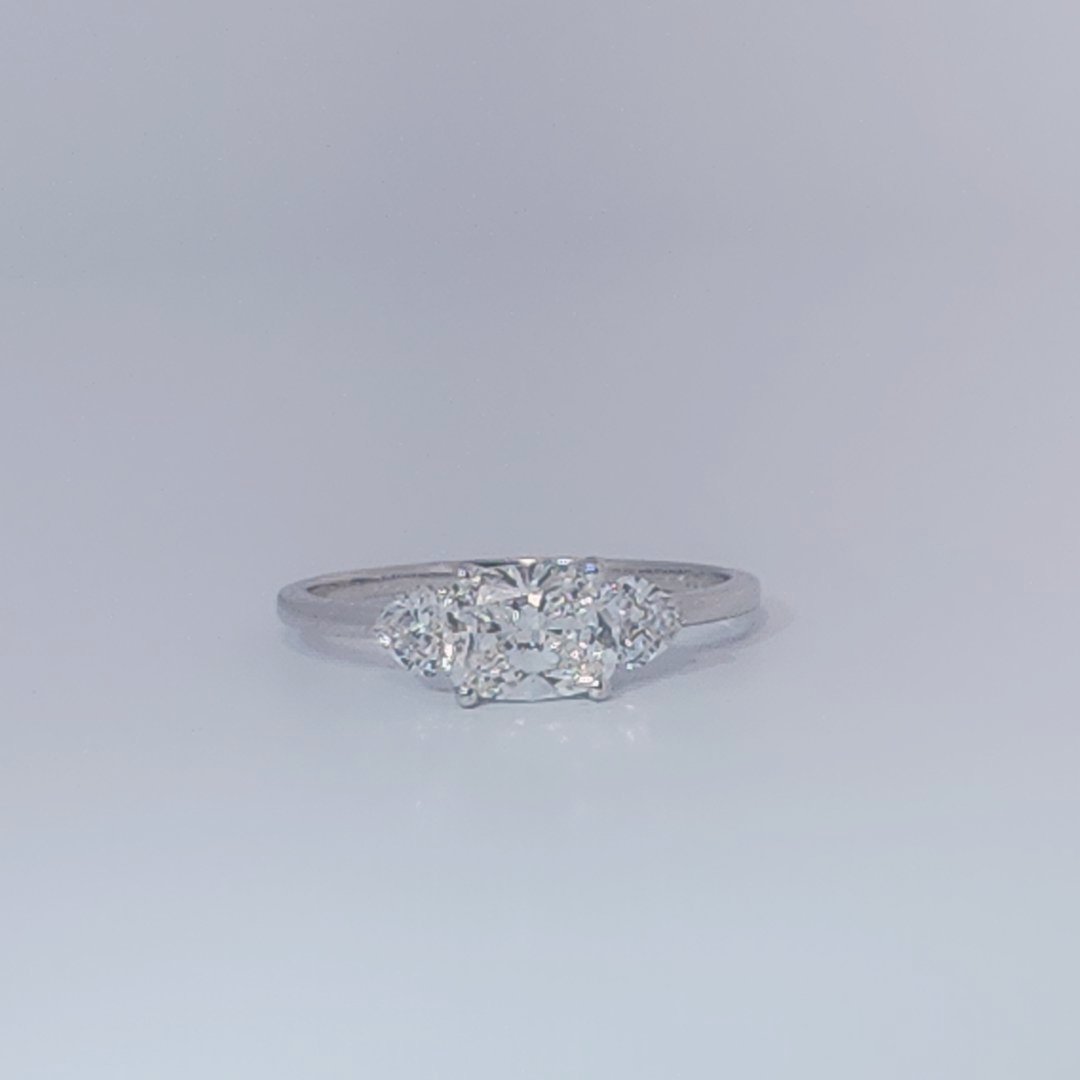 Women's Three-Stone Ring, 14K White Gold, featuring a 1.01ct D/VS2 Radiant-cut Diamond and two 0.31ct side Diamonds.