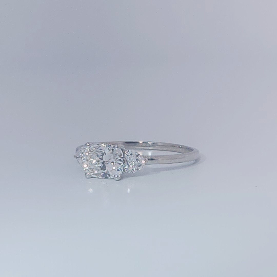 Women's Three-Stone Ring, 14K White Gold, featuring a 1.01ct D/VS2 Radiant-cut Diamond and two 0.31ct side Diamonds.
