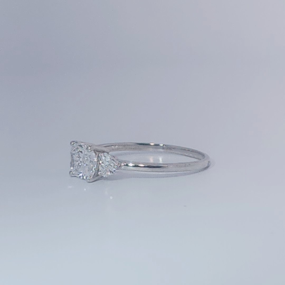 Women's Three-Stone Ring, 14K White Gold, featuring a 1.01ct D/VS2 Radiant-cut Diamond and two 0.31ct side Diamonds.