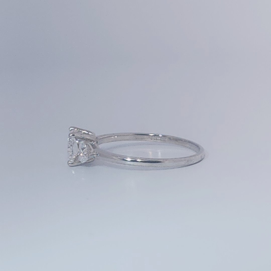 Women's Three-Stone Ring, 14K White Gold, featuring a 1.01ct D/VS2 Radiant-cut Diamond and two 0.31ct side Diamonds.