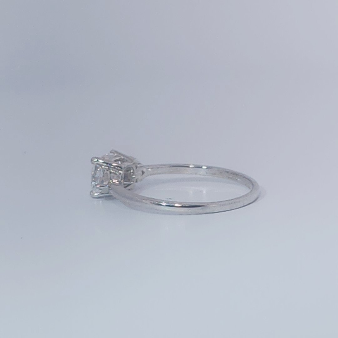 Women's Three-Stone Ring, 14K White Gold, featuring a 1.01ct D/VS2 Radiant-cut Diamond and two 0.31ct side Diamonds.