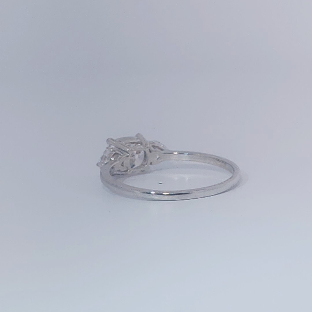 Women's Three-Stone Ring, 14K White Gold, featuring a 1.01ct D/VS2 Radiant-cut Diamond and two 0.31ct side Diamonds.