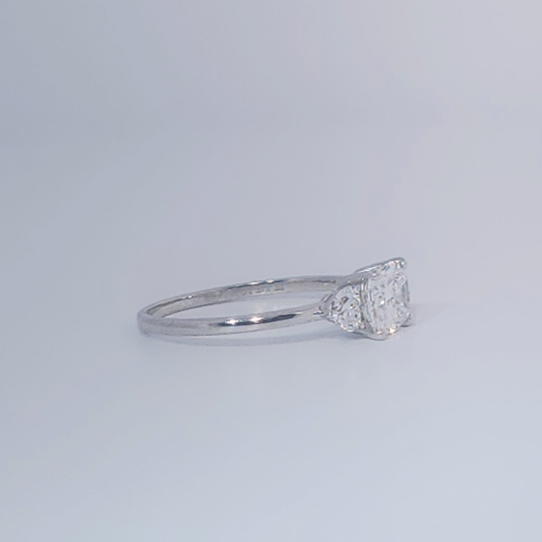 Women's Three-Stone Ring, 14K White Gold, featuring a 1.01ct D/VS2 Radiant-cut Diamond and two 0.31ct side Diamonds.