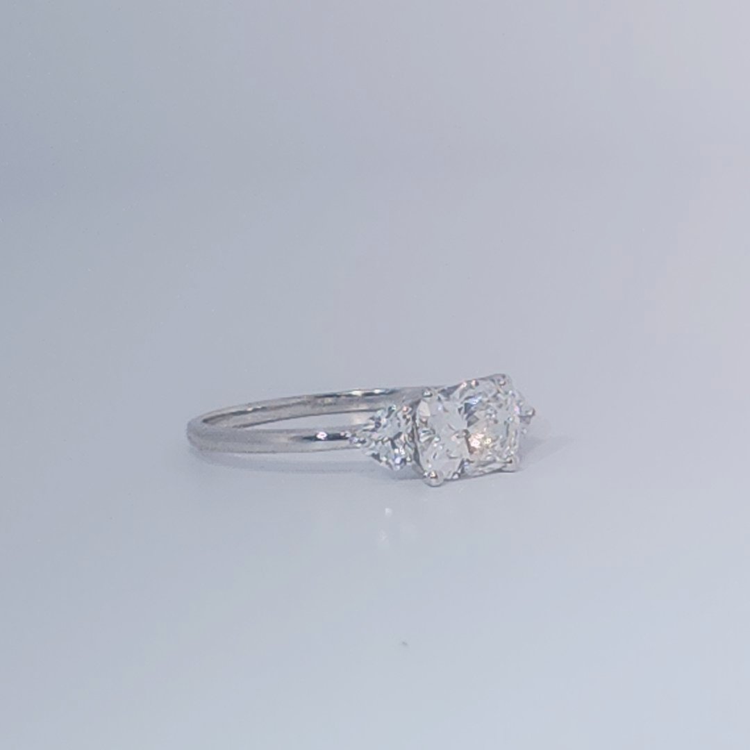 Women's Three-Stone Ring, 14K White Gold, featuring a 1.01ct D/VS2 Radiant-cut Diamond and two 0.31ct side Diamonds.
