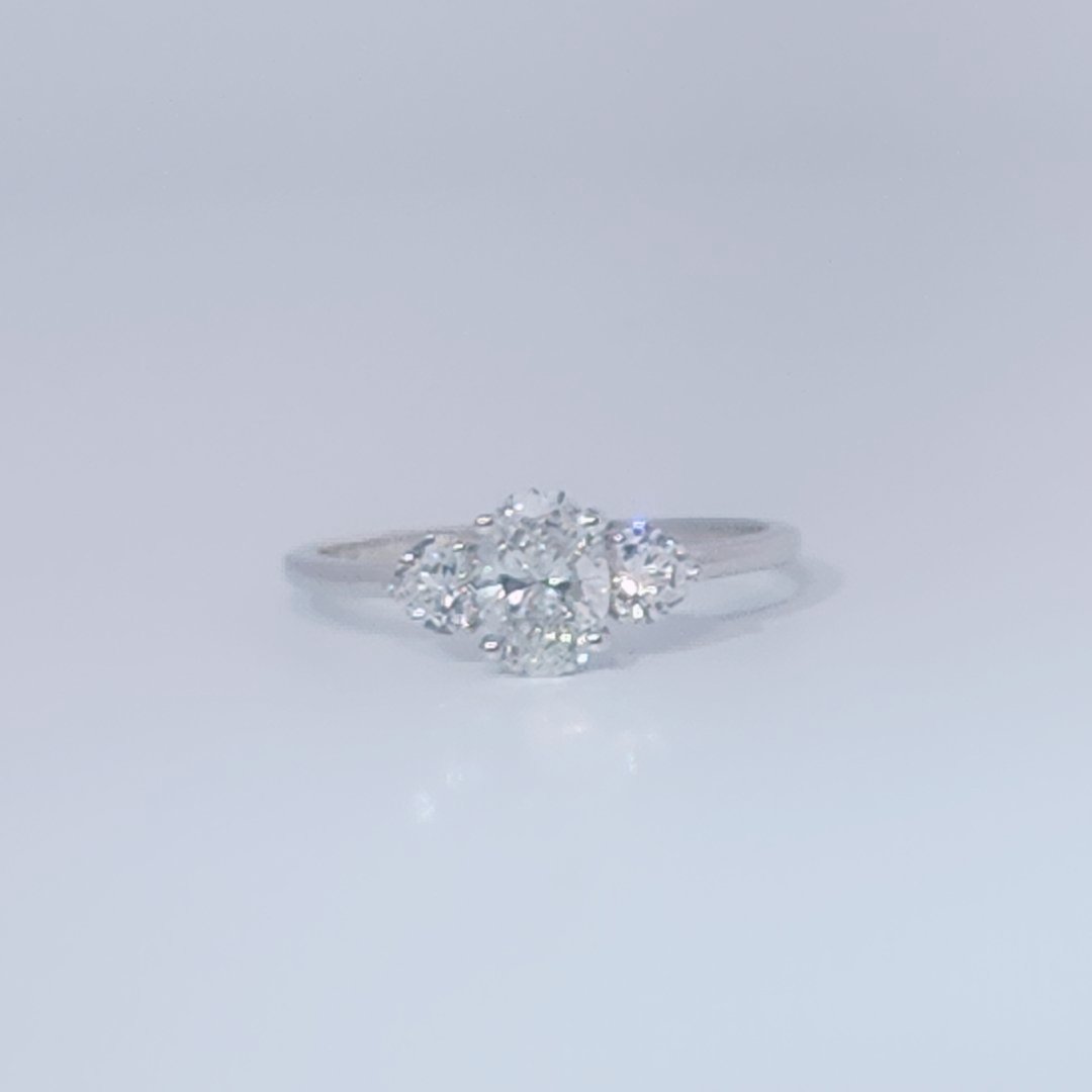 Women's 3-stone Ring in 14K White Gold with a 0.71ct D color (colorless) center Diamond and two 0.31ct F color (colorless) side Diamonds.