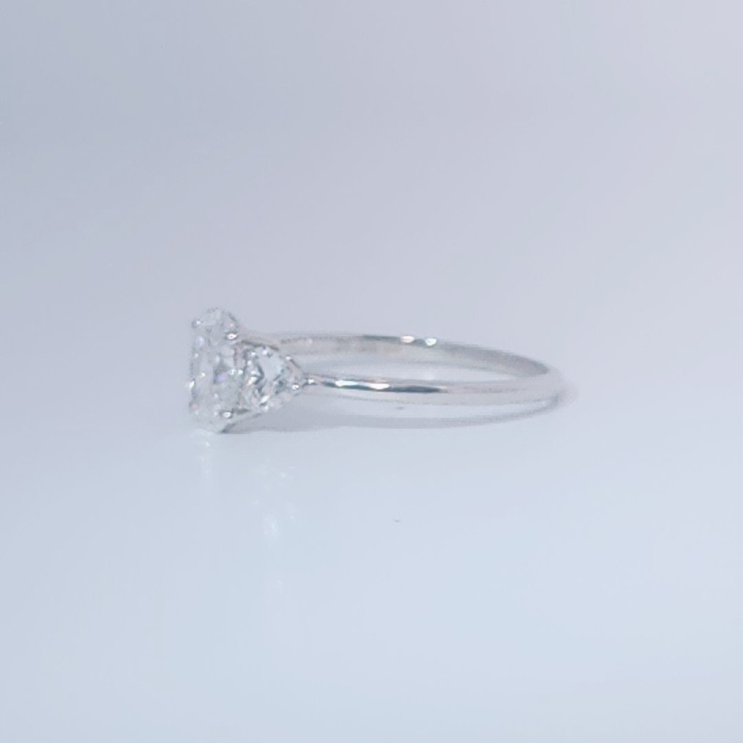Women's 3-stone Ring in 14K White Gold with a 0.71ct D color (colorless) center Diamond and two 0.31ct F color (colorless) side Diamonds.