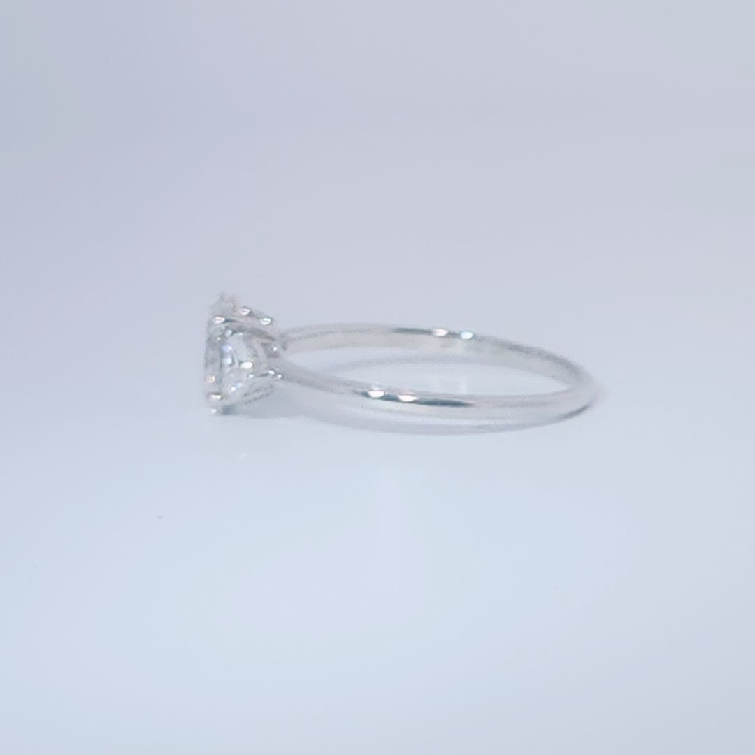 Women's 3-stone Ring in 14K White Gold with a 0.71ct D color (colorless) center Diamond and two 0.31ct F color (colorless) side Diamonds.