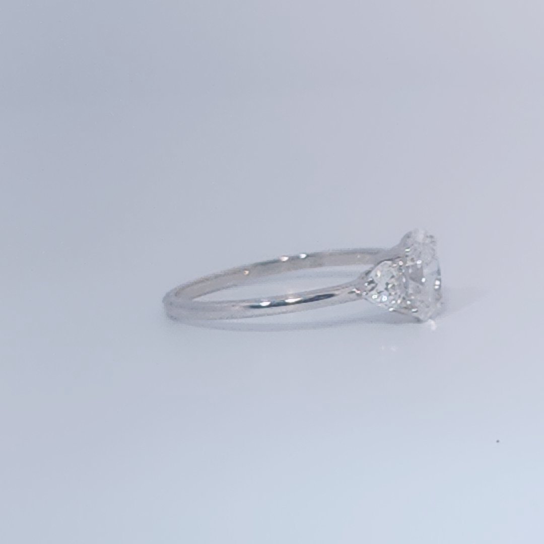 Women's 3-stone Ring in 14K White Gold with a 0.71ct D color (colorless) center Diamond and two 0.31ct F color (colorless) side Diamonds.