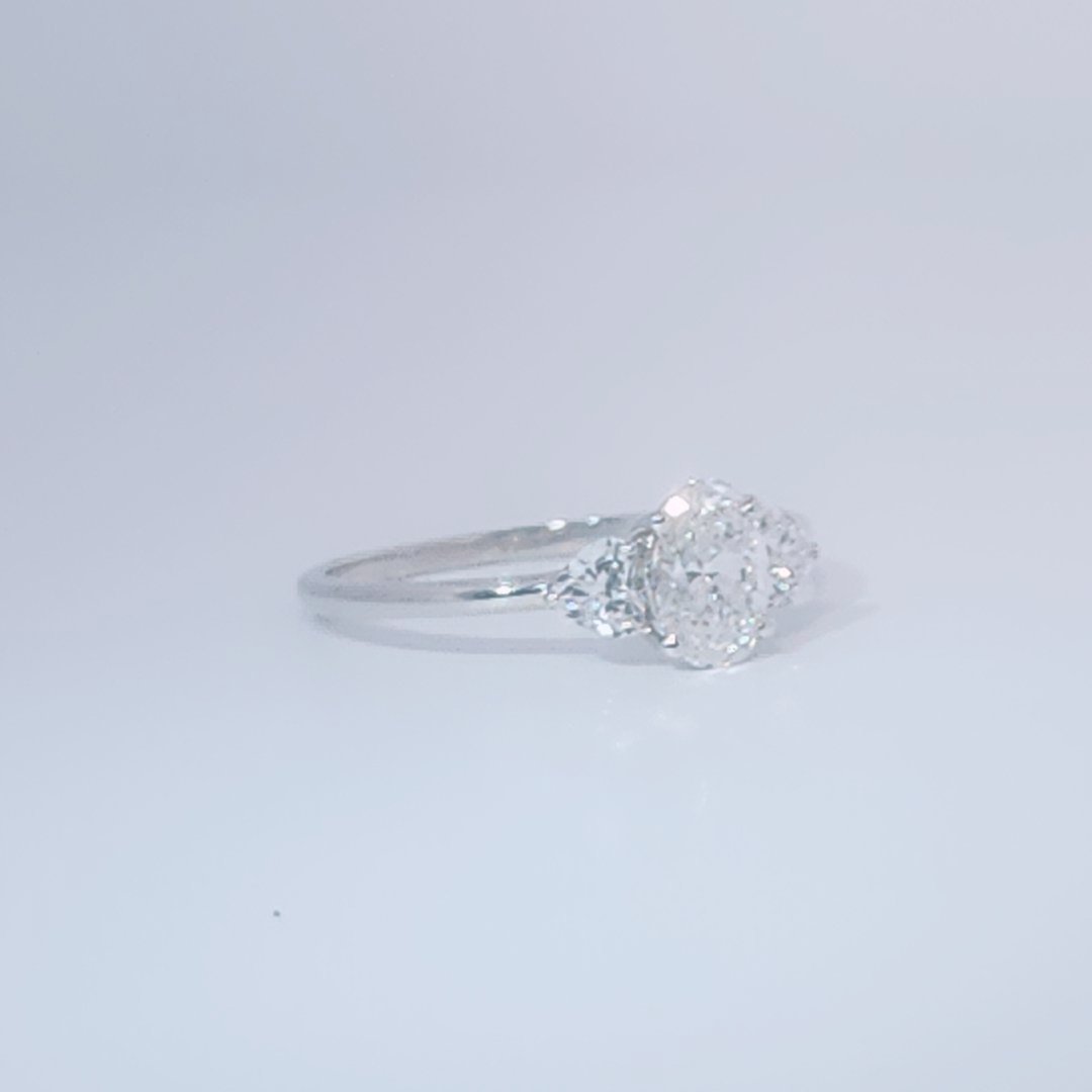 Women's 3-stone Ring in 14K White Gold with a 0.71ct D color (colorless) center Diamond and two 0.31ct F color (colorless) side Diamonds.