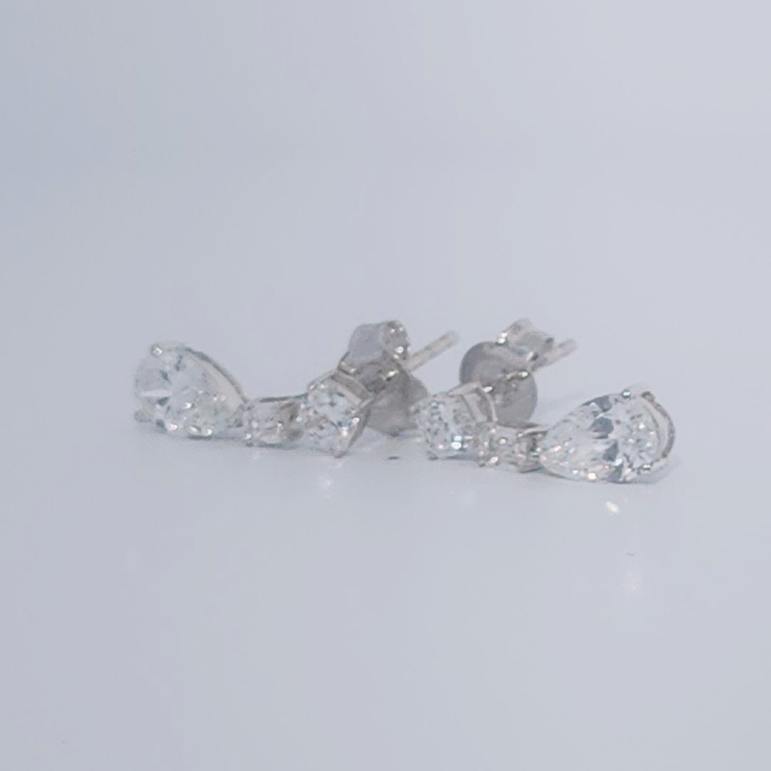 Female Diamond cluster Earrings, 2K White Gold, graduated pear and baguette-cut Diamonds totaling 1.88ct.