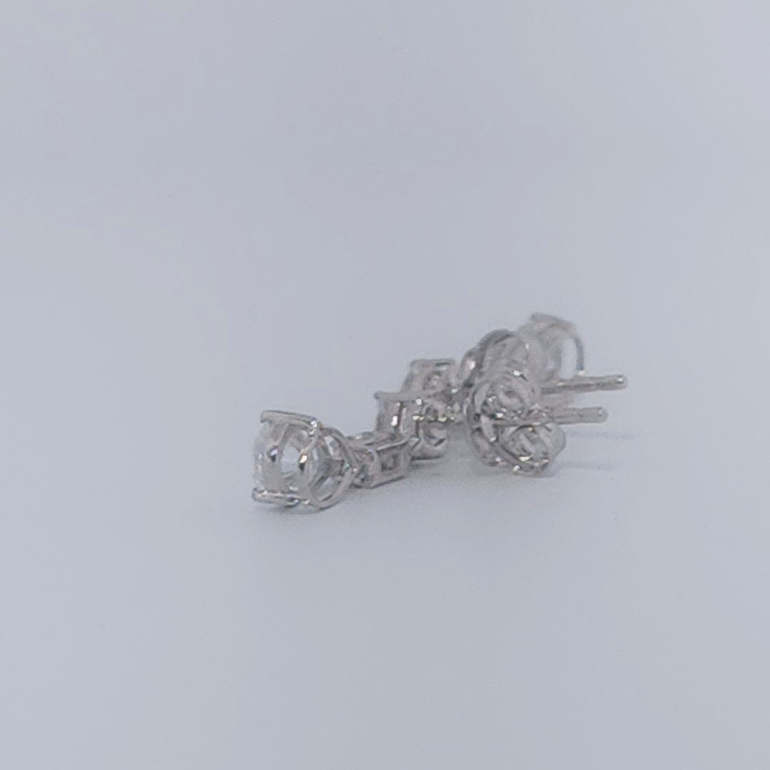 Female Diamond cluster Earrings, 2K White Gold, graduated pear and baguette-cut Diamonds totaling 1.88ct.