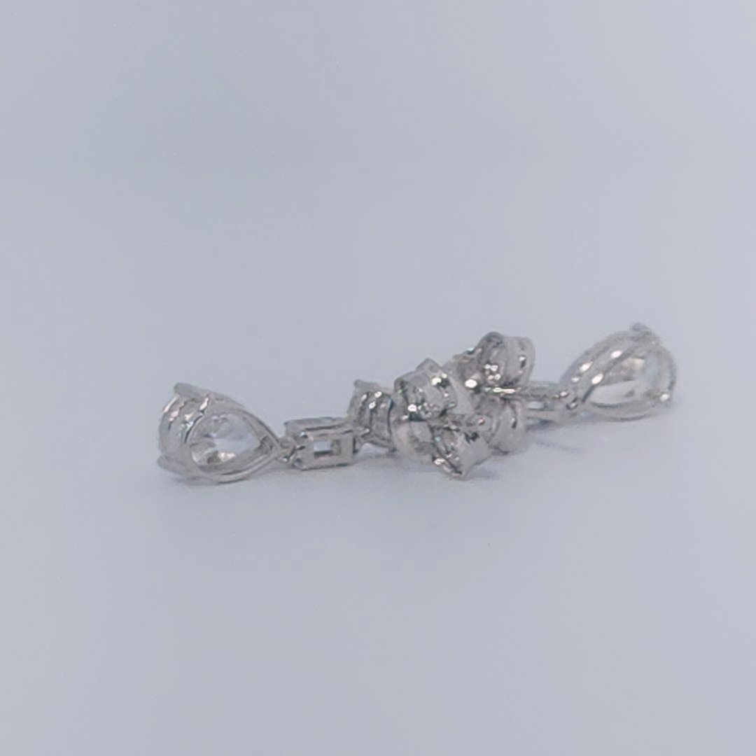 Female Diamond cluster Earrings, 2K White Gold, graduated pear and baguette-cut Diamonds totaling 1.88ct.