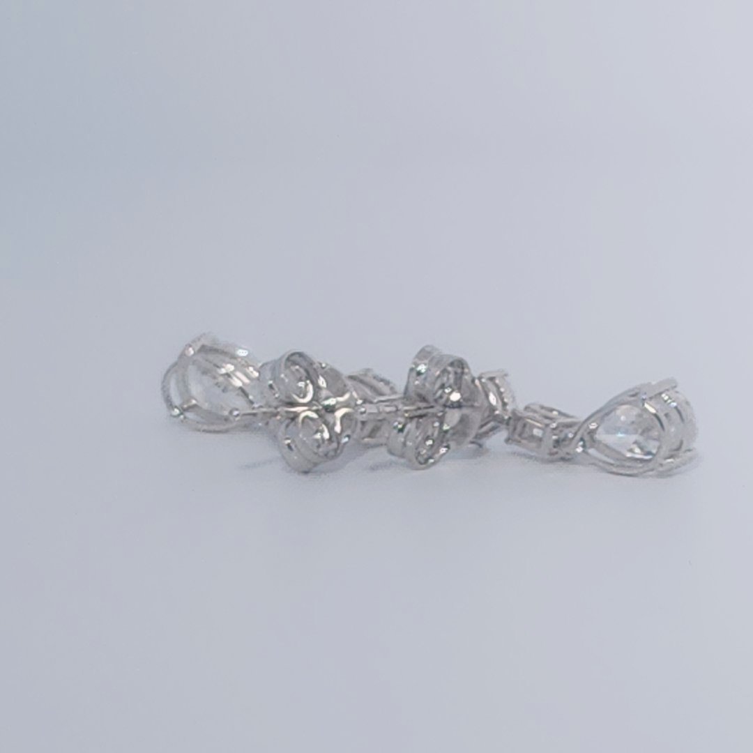Female Diamond cluster Earrings, 2K White Gold, graduated pear and baguette-cut Diamonds totaling 1.88ct.