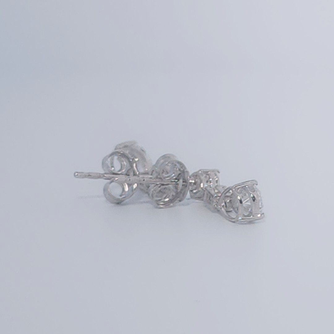 Female Diamond cluster Earrings, 2K White Gold, graduated pear and baguette-cut Diamonds totaling 1.88ct.