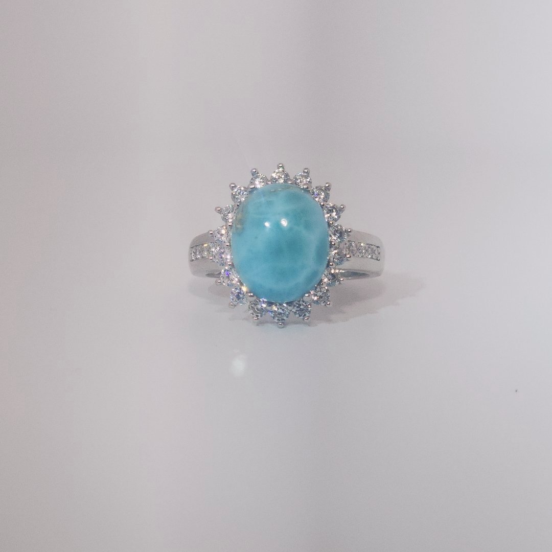 Women's Sterling Silver Ring with oval blue Larimar center stone, accented by round Cubic Zirconia in halo and band setting.