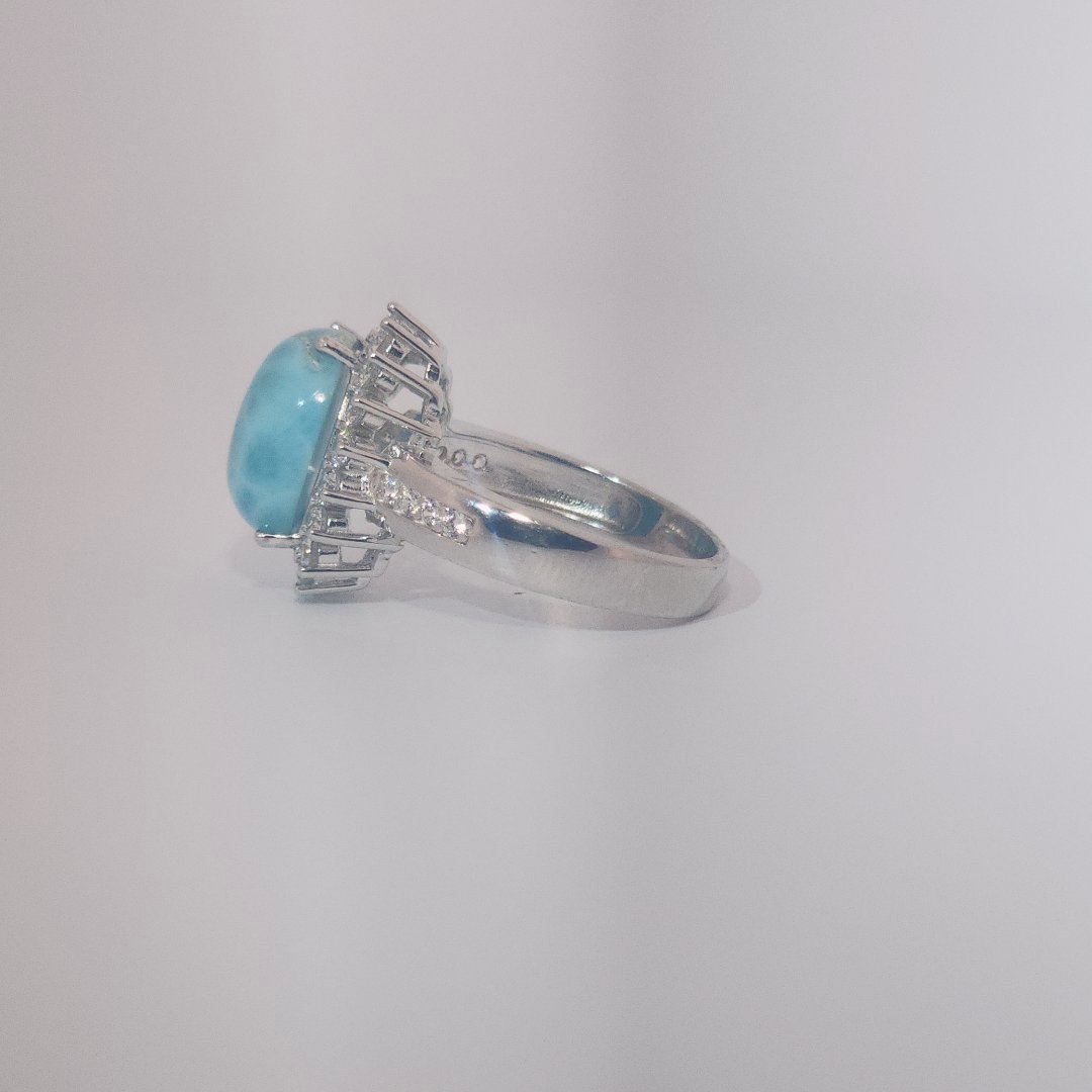Women's Sterling Silver Ring with oval blue Larimar center stone, accented by round Cubic Zirconia in halo and band setting.