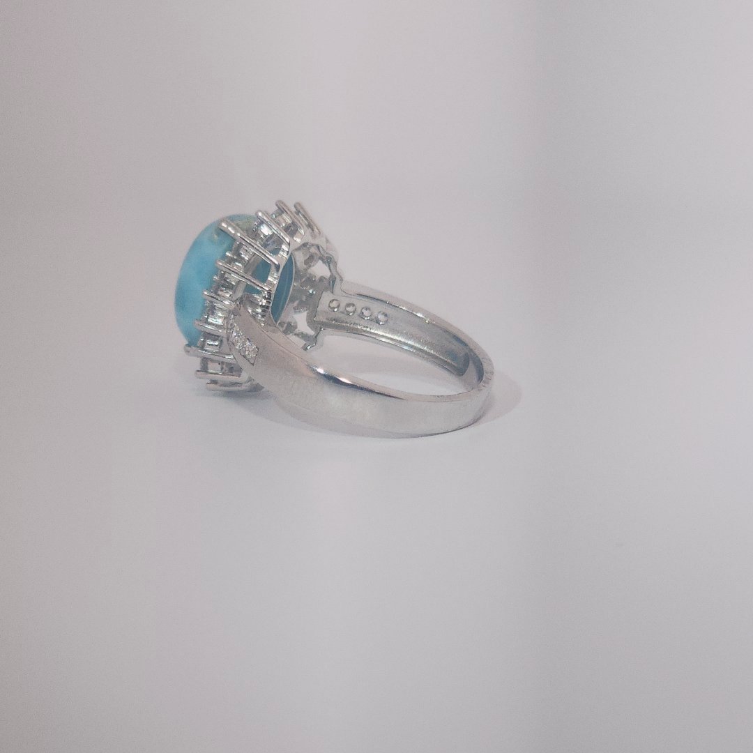 Women's Sterling Silver Ring with oval blue Larimar center stone, accented by round Cubic Zirconia in halo and band setting.
