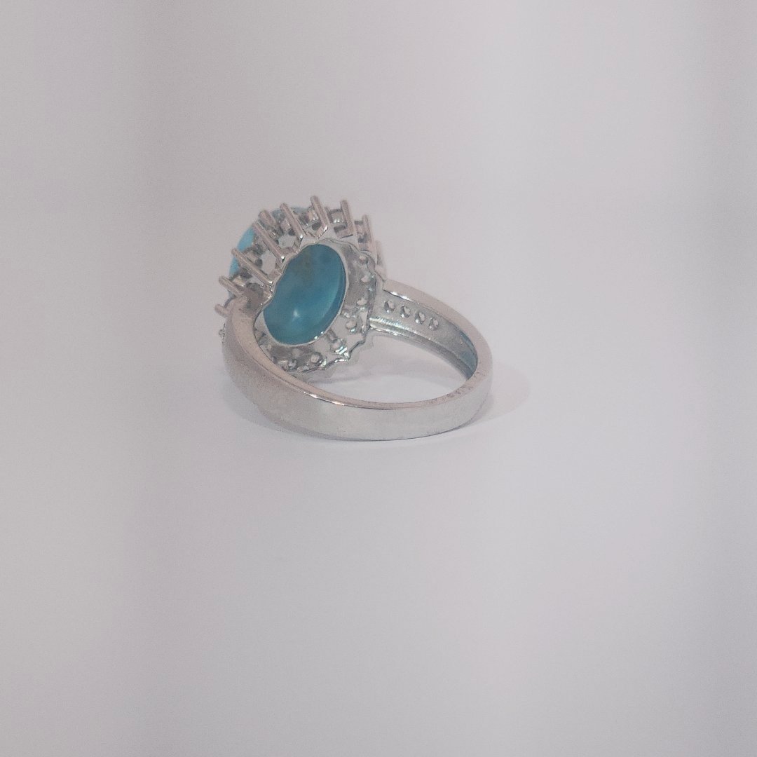 Women's Sterling Silver Ring with oval blue Larimar center stone, accented by round Cubic Zirconia in halo and band setting.