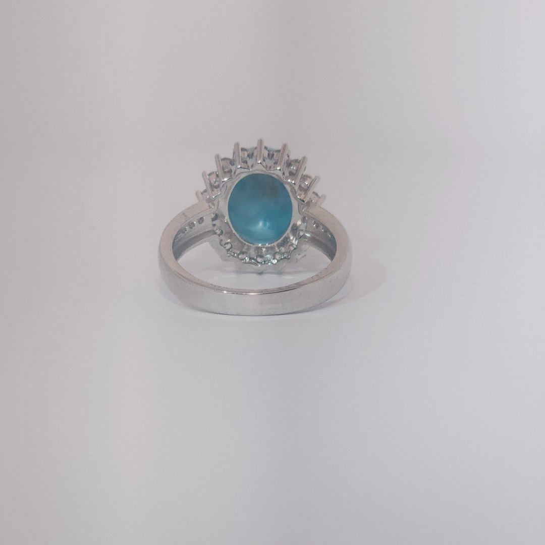 Women's Sterling Silver Ring with oval blue Larimar center stone, accented by round Cubic Zirconia in halo and band setting.