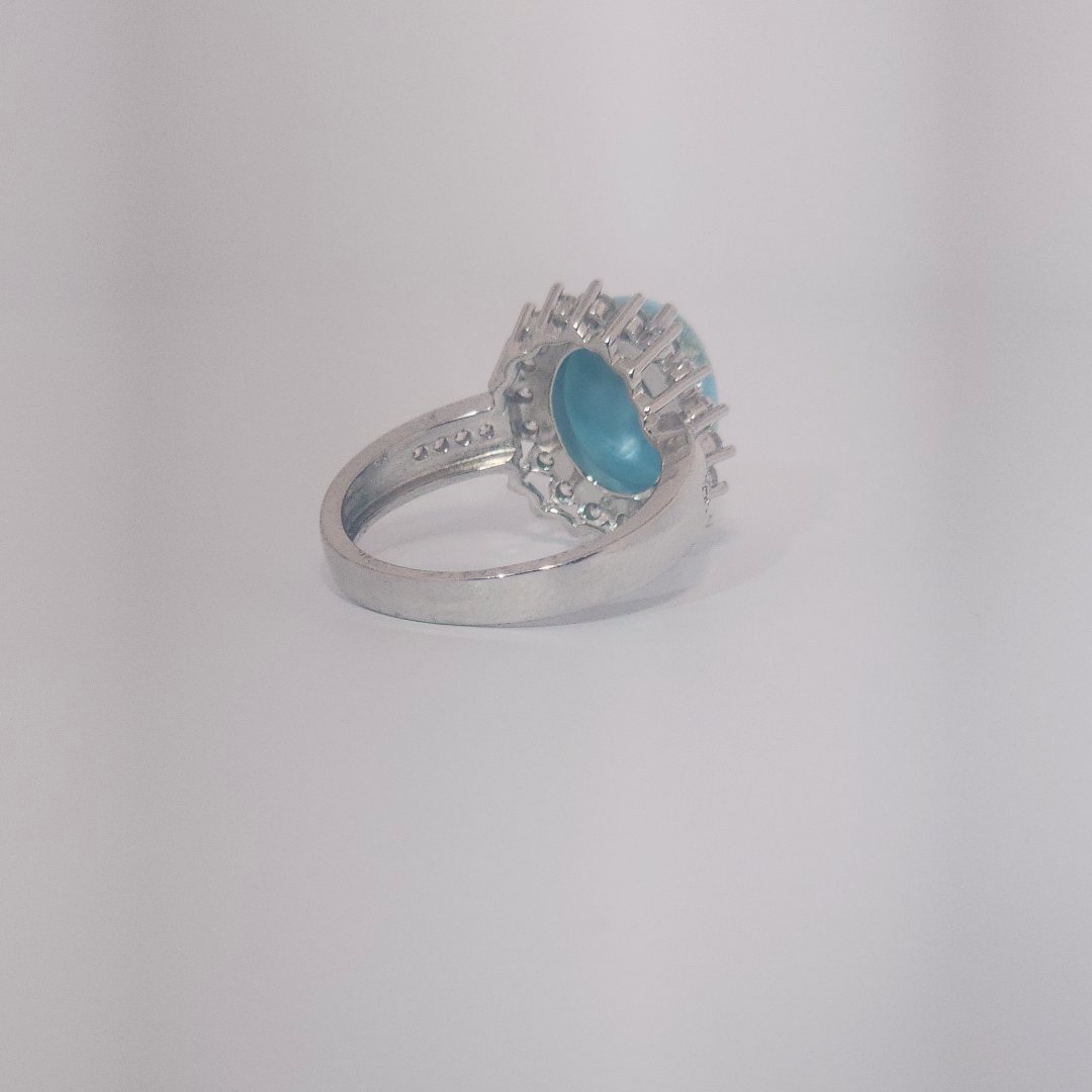 Women's Sterling Silver Ring with oval blue Larimar center stone, accented by round Cubic Zirconia in halo and band setting.