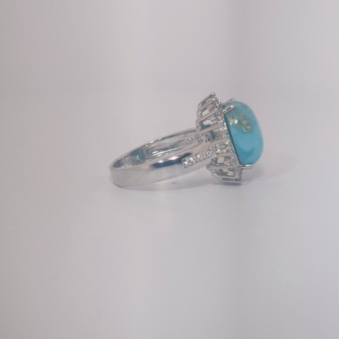 Women's Sterling Silver Ring with oval blue Larimar center stone, accented by round Cubic Zirconia in halo and band setting.