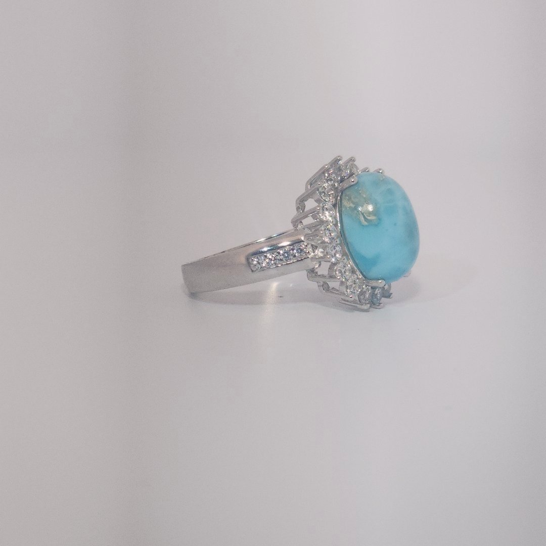 Women's Sterling Silver Ring with oval blue Larimar center stone, accented by round Cubic Zirconia in halo and band setting.