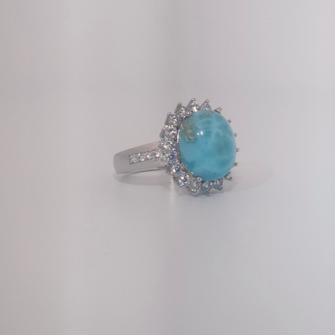 Women's Sterling Silver Ring with oval blue Larimar center stone, accented by round Cubic Zirconia in halo and band setting.